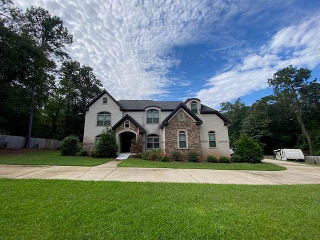 french provincial home featuring a front lawn