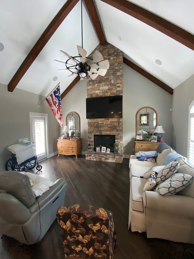 living room featuring dark wood-type flooring, high vaulted ceiling, a stone fireplace, ceiling fan, and beamed ceiling