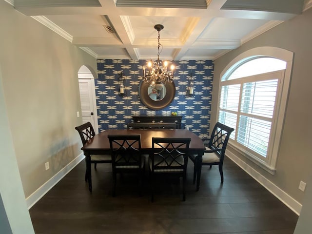 dining room with crown molding, dark wood-type flooring, and an inviting chandelier