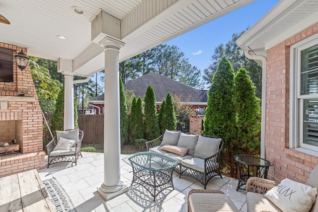 view of patio featuring an outdoor living space with a fireplace