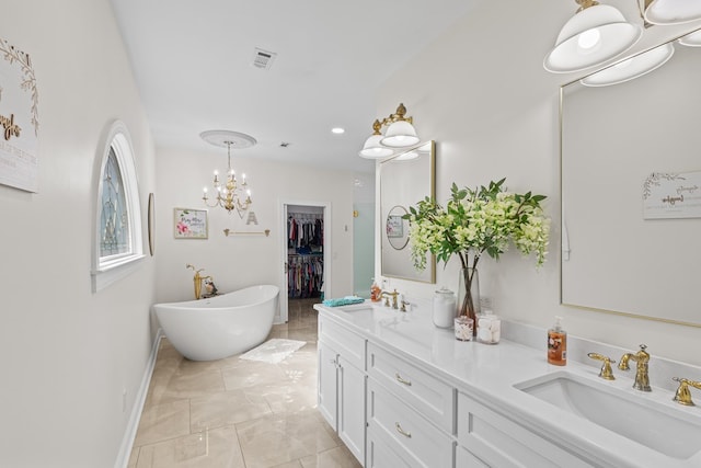full bathroom with a freestanding bath, a sink, visible vents, and double vanity