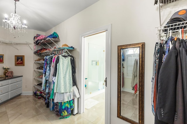 spacious closet featuring light tile patterned floors and a notable chandelier