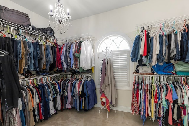 spacious closet featuring tile patterned flooring and a notable chandelier