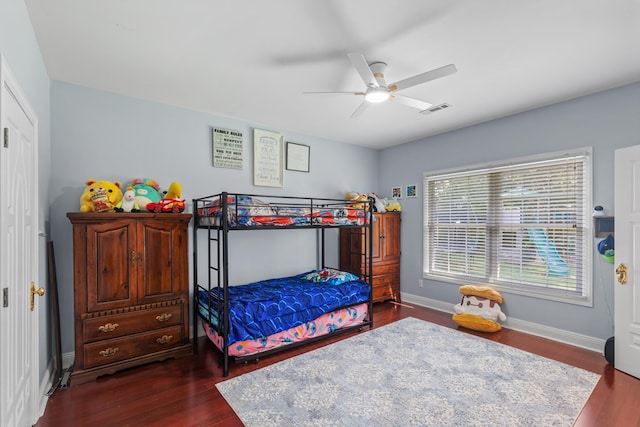 bedroom with visible vents, a ceiling fan, baseboards, and dark wood-style flooring