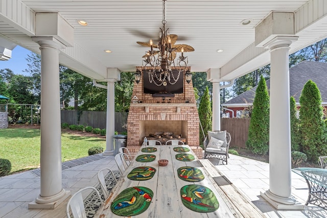 view of patio with ceiling fan and an outdoor brick fireplace