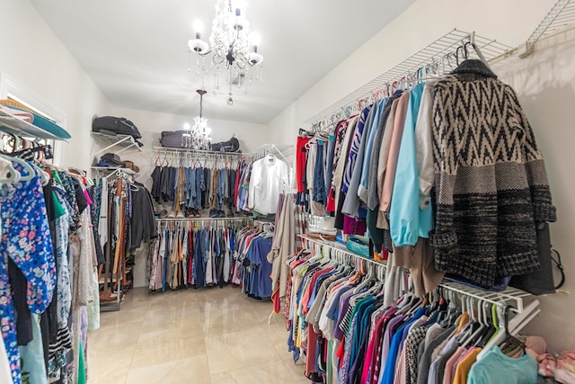 walk in closet with a notable chandelier