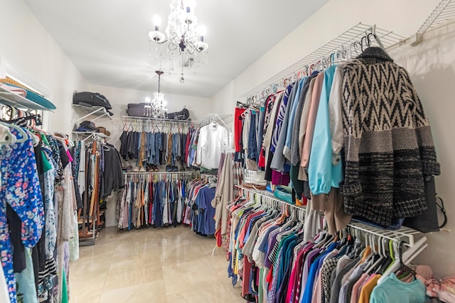 spacious closet featuring an inviting chandelier