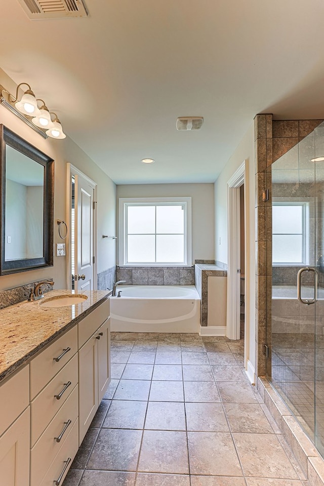 120 Puent Dr, Dothan, AL 36301 - bathroom with a stall shower, double vanity, a garden tub, and tile patterned flooring
