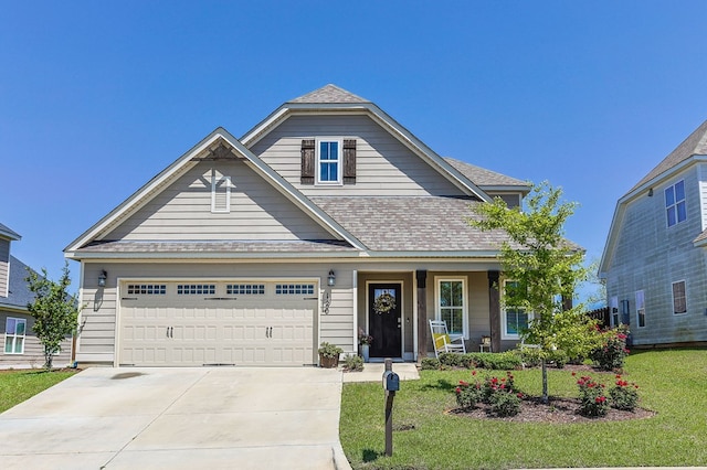 120 Puent Dr, Dothan, AL 36301 - view of front facade with a porch, a front yard, concrete driveway, and a shingled roof