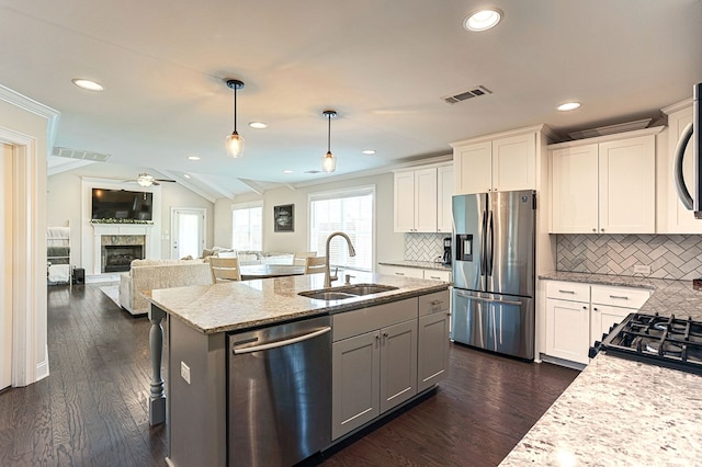 120 Puent Dr, Dothan, AL 36301 - kitchen featuring appliances with stainless steel finishes, a sink, light stone counters, white cabinetry, and decorative backsplash