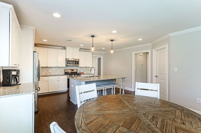 120 Puent Dr, Dothan, AL 36301 - kitchen featuring appliances with stainless steel finishes, a sink, white cabinetry, decorative backsplash, and recessed lighting