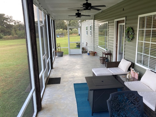 sunroom featuring ceiling fan and a healthy amount of sunlight