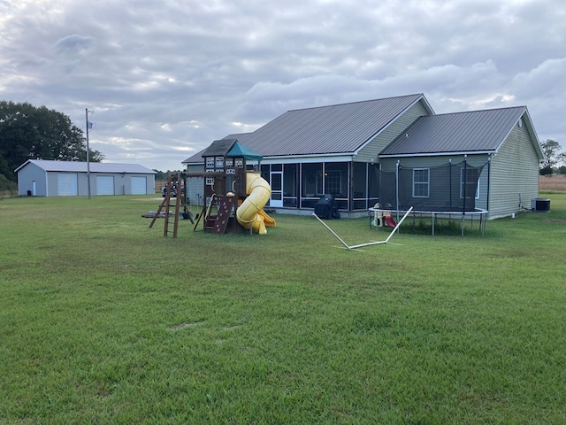 view of yard featuring a playground, a trampoline, cooling unit, and a sunroom