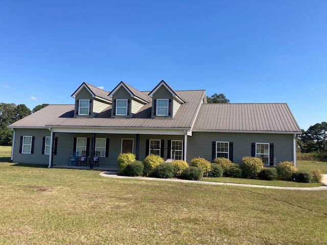 cape cod house with a porch and a front yard