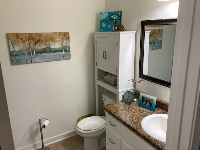 bathroom featuring tile patterned flooring, vanity, and toilet