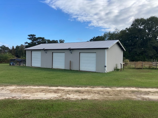 garage featuring a lawn