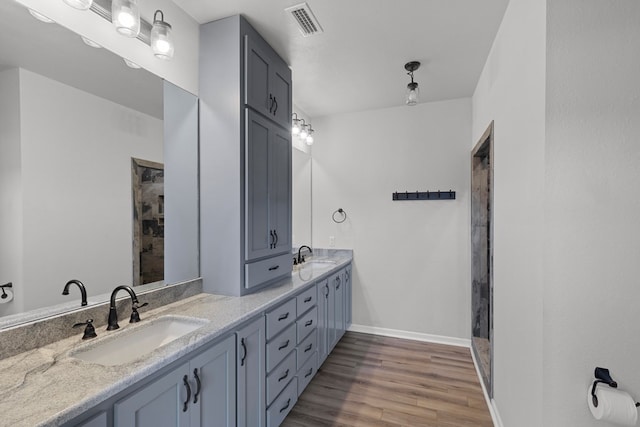 bathroom with vanity and hardwood / wood-style flooring