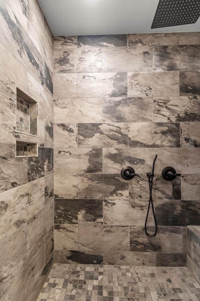 bathroom with a tile shower