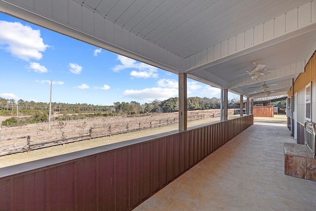 view of patio / terrace featuring ceiling fan and a rural view