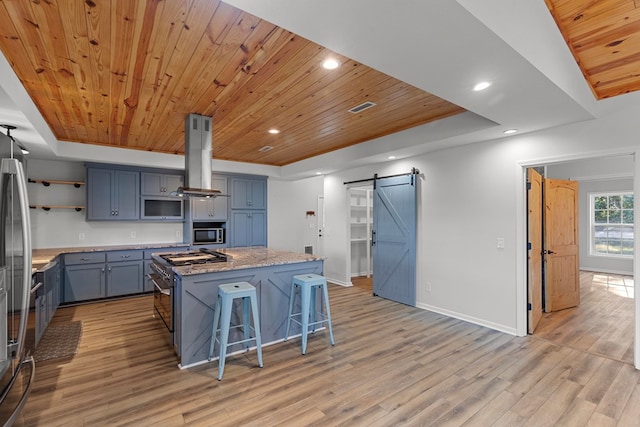 kitchen featuring island range hood, wooden ceiling, a barn door, and a kitchen island