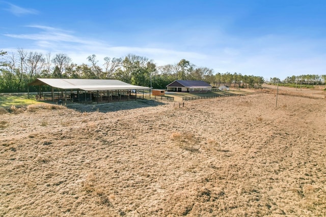 view of yard with a rural view and an outbuilding