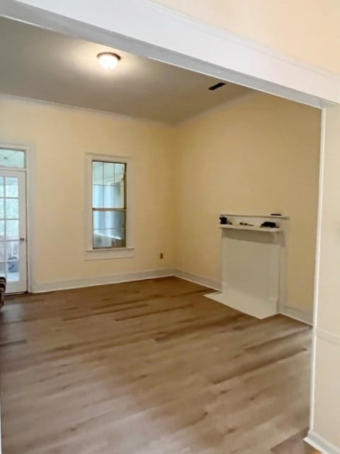 unfurnished room featuring baseboards and light wood finished floors