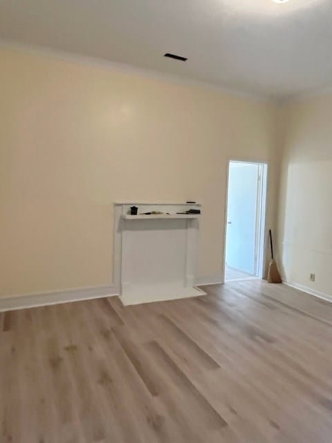 spare room featuring wood finished floors and baseboards