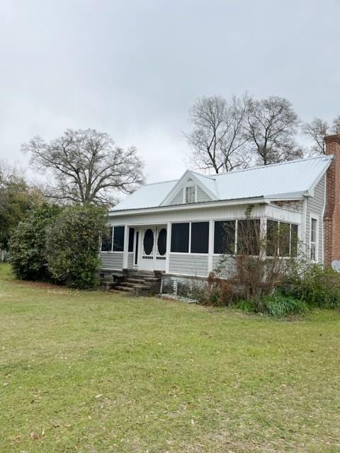 view of front of property featuring a chimney and a front lawn