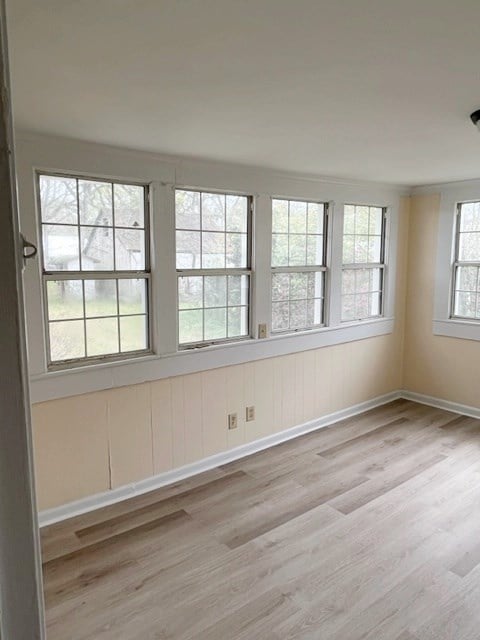 empty room featuring baseboards and wood finished floors