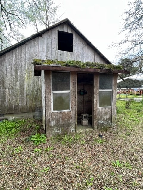 view of outbuilding with a detached carport and an outdoor structure