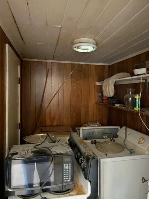 laundry room with wood ceiling, washer / dryer, wood walls, and laundry area