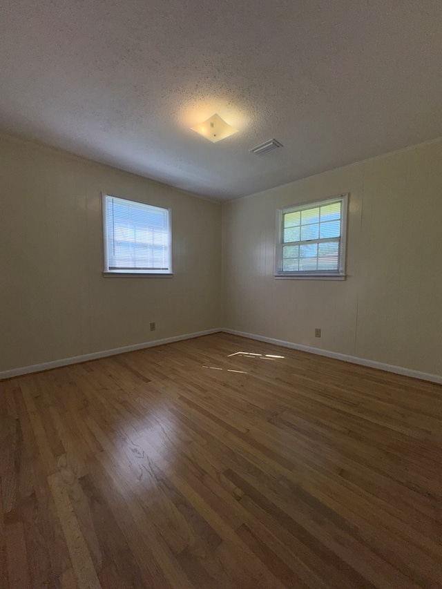 629 Coe Dairy Rd, Dothan, AL 36301 - unfurnished room featuring healthy amount of natural light, wood finished floors, a textured ceiling, and baseboards