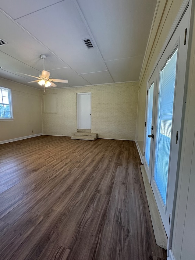 629 Coe Dairy Rd, Dothan, AL 36301 - empty room featuring dark wood finished floors, a ceiling fan, baseboards, and brick wall