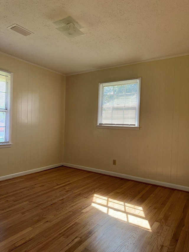 629 Coe Dairy Rd, Dothan, AL 36301 - spare room featuring wood finished floors, a textured ceiling, crown molding, and baseboards