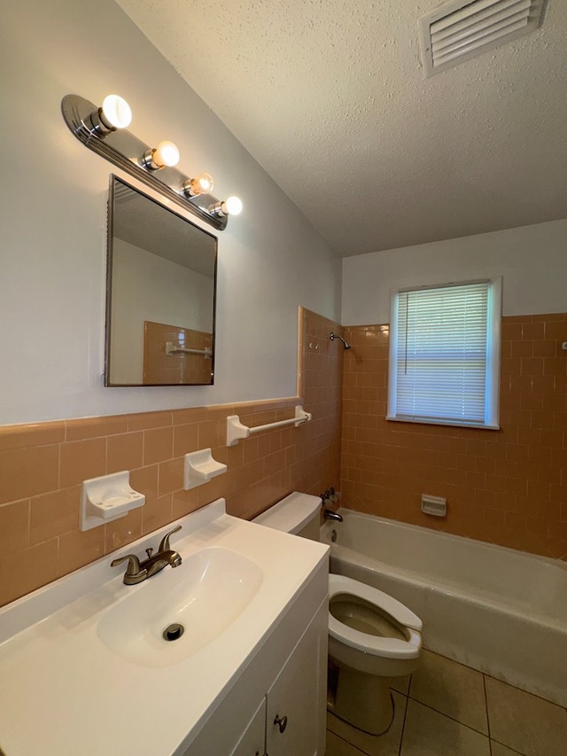629 Coe Dairy Rd, Dothan, AL 36301 - bathroom with tile walls, tile patterned floors, tub / shower combination, toilet, and vanity
