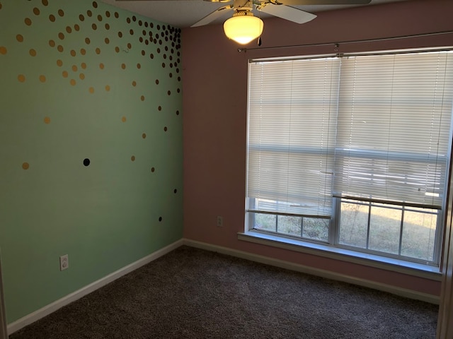 empty room with ceiling fan, carpet floors, and baseboards