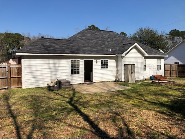 back of property featuring a patio, a lawn, and fence