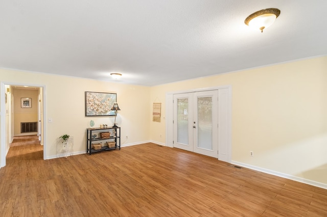 unfurnished room featuring hardwood / wood-style flooring and french doors