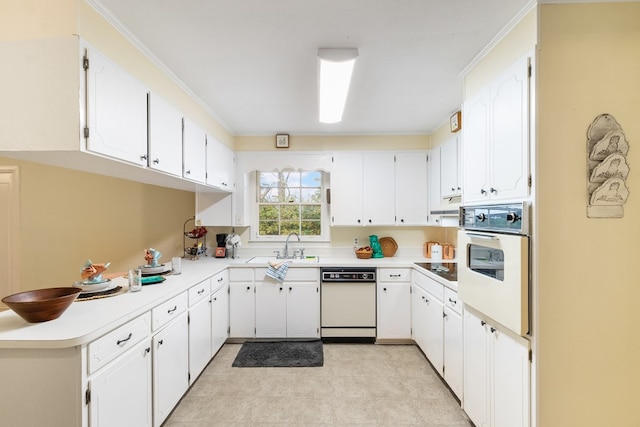 kitchen with white cabinetry, sink, crown molding, and white appliances