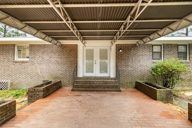 view of exterior entry with french doors and a patio