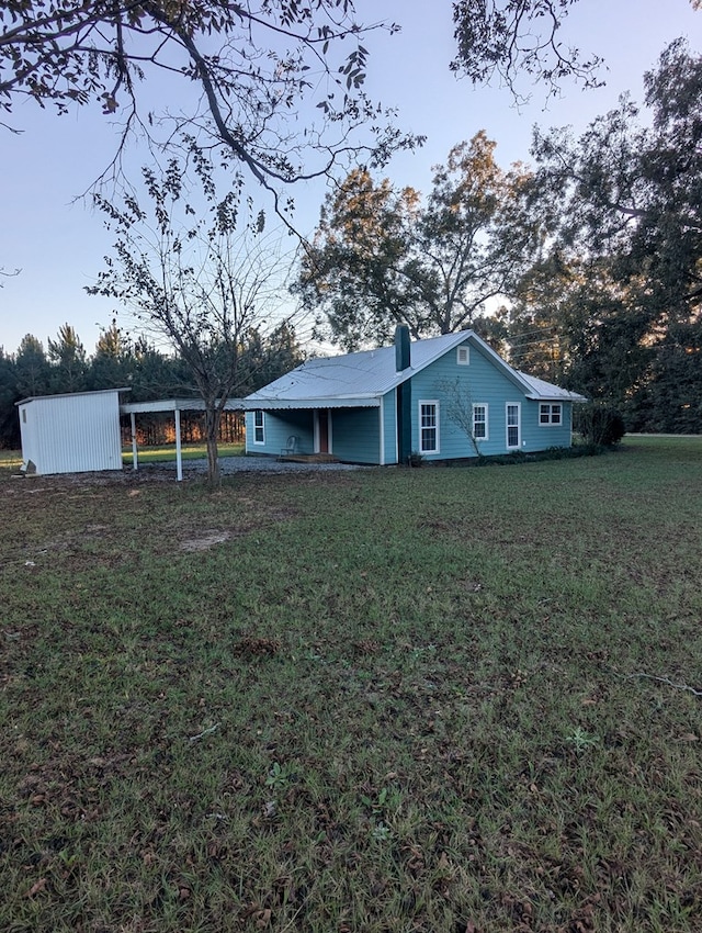 view of front of home with a chimney and a front yard