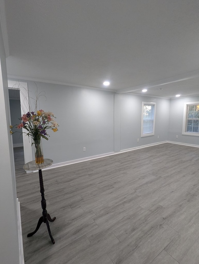 below grade area with baseboards, wood finished floors, and recessed lighting