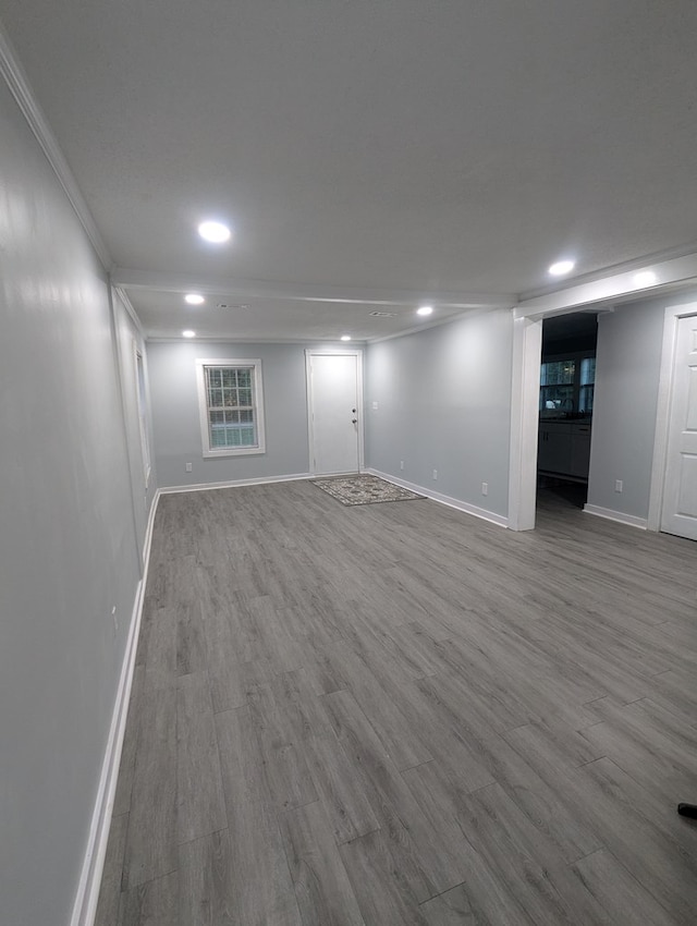 below grade area with crown molding, recessed lighting, wood finished floors, and baseboards