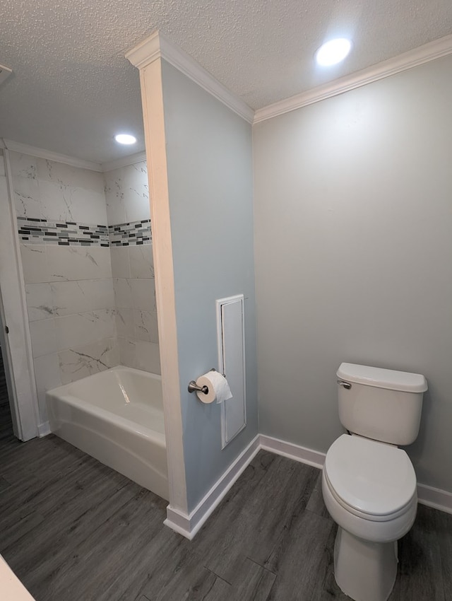 bathroom featuring a textured ceiling, wood finished floors, toilet, and crown molding