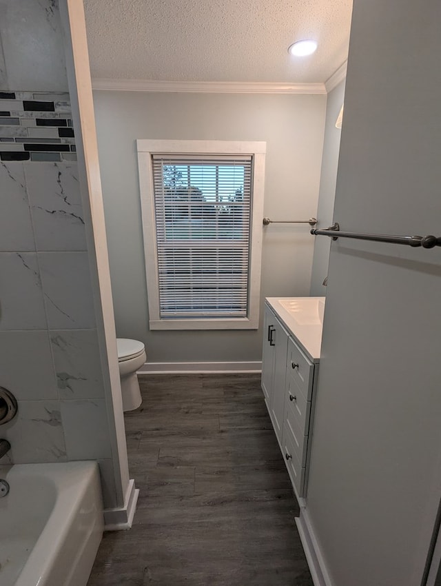 full bathroom featuring toilet, a textured ceiling, crown molding, and wood finished floors