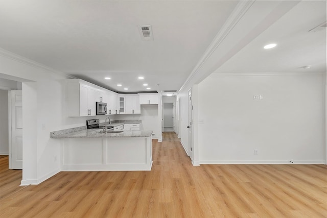 kitchen with light stone counters, stainless steel appliances, a peninsula, crown molding, and glass insert cabinets