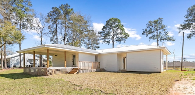 view of front facade featuring a front lawn, covered porch, and metal roof