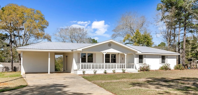 single story home with a front yard, covered porch, metal roof, a carport, and driveway