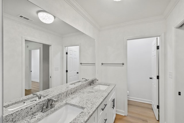 full bathroom with toilet, wood finished floors, visible vents, and a sink