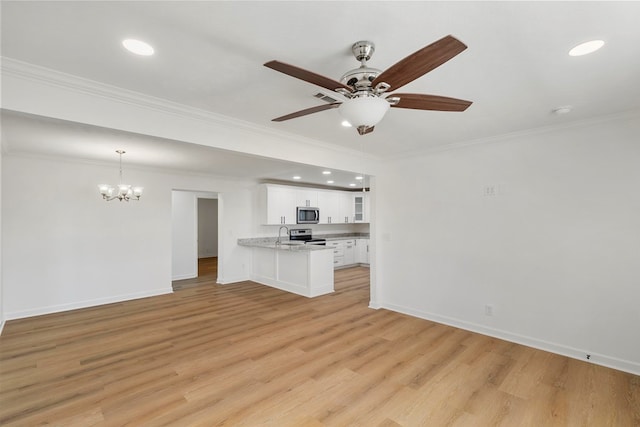 unfurnished living room with baseboards, light wood finished floors, recessed lighting, ornamental molding, and ceiling fan with notable chandelier